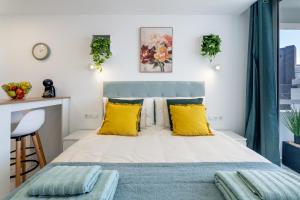 a bedroom with a large bed with yellow pillows at Costa Serena Apartment 420 in Costa de Adeje +14 photos