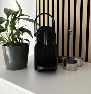 a black iron sitting on a counter next to a plant at Studio Galerie 473 L'art de vivre à Metz in Metz