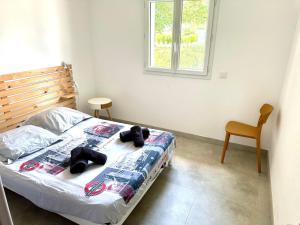 a bedroom with a bed with two teddy bears on it at Maison 10 couchages in Romorantin