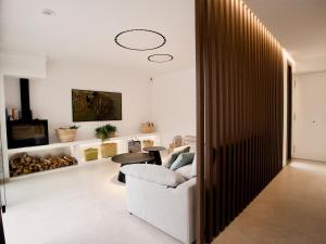 a living room with a white couch and a table at Stunning Design Villa with large private Pool 30sqm in Caserío Bufagañas