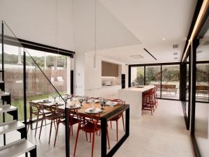 a dining room and kitchen with a table and chairs at Stunning Design Villa with large private Pool 30sqm in Caserío Bufagañas
