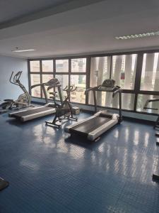 a gym with several tread machines in a room at bayviewmansion malate in Manila