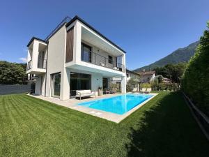 a house with a swimming pool in the yard at Villa Lake Luxury in Colico