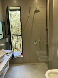a bathroom with a shower and a toilet and a sink at Villa Arantia in Vlorë
