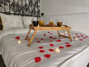 a bed with a table with hearts and candles on it at Studio & Balnéo privatif in Évreux