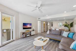 a living room with a couch and a table at Treasure Island Waterfront home - 100ft to beach! in St Pete Beach