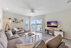 a living room with a couch and a table at Treasure Island Waterfront home - 100ft to beach! in St Pete Beach +28 photos