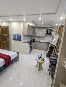 a large room with a bed and a kitchen at Luxury Designer Studio Apartment Mehar Suites Bahria Self Checkin in Lahore +14 photos
