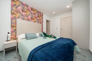 a bedroom with a large bed with a colorful wall at Villa Marko Forever in Makarska +78 photos