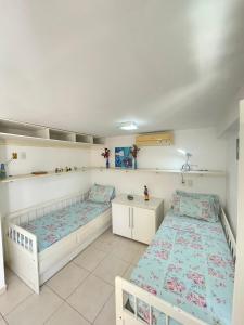 En eller flere senge i et værelse på Ape Familia c Ar e prox Praias e Centro Búzios 4p