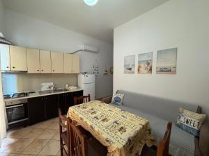 a small kitchen with a table and a table and a table and a kitchen gmaxwell at Mira Orikum in Orikum