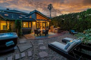 a backyard with a hot tub and a house at Tropical Retreat North by Paradise Retreats in Santa Barbara