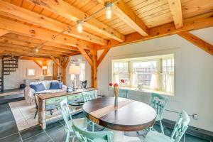a living room with a wooden ceiling and a table and chairs at Cozy Pet-Friendly Cottage Near Fort Knox and Acadia in Penobscot