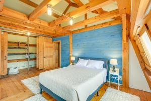 a bedroom with a bed and a wooden wall at Cozy Pet-Friendly Cottage Near Fort Knox and Acadia in Penobscot