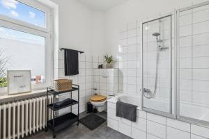 a bathroom with a tub and a toilet and a window at Altbaujuwel in Schwelm, nahe Köln,DO,Df 4 Pers in Schwelm