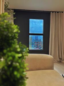 a living room with a couch and a window at 3 KING beds Free Parking Modern Luxe Escape in Pittsburgh