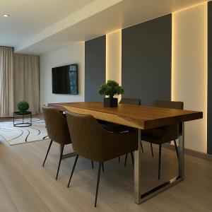 a dining room with a wooden table and chairs at 3 KING beds Free Parking Modern Luxe Escape in Pittsburgh