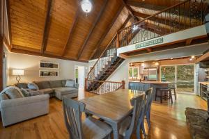 a dining room and living room with a wooden ceiling at Lake Hills Hideaway in Wilkesboro +40 photos