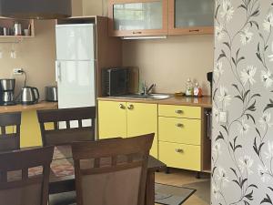 a kitchen with yellow cabinets and a yellow refrigerator at Akord Apartments with FREE PARKING in Pärnu +25 photos