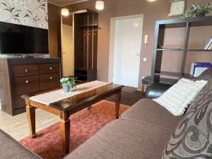 a living room with a couch and a coffee table at Akord Apartments with FREE PARKING in Pärnu