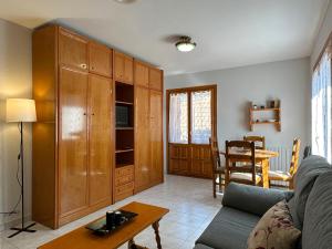 a living room with a couch and a table at Apartamentos Lausan in Gavín