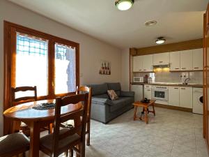 a living room with a couch and a table at Apartamentos Lausan in Gavín