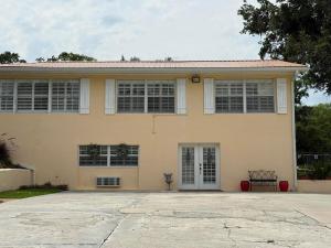 a house with a large driveway in front of it at Cozy Retreat in the Heart of it all! in Brooksville
