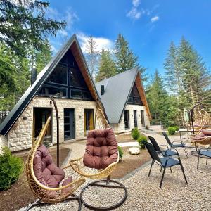 a group of chairs and chairs in front of a house at Forest Whisper SPA in Žabljak