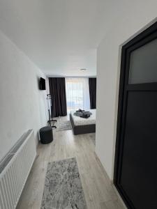 a white room with a bed and a window at CasaA&B in Dubova
