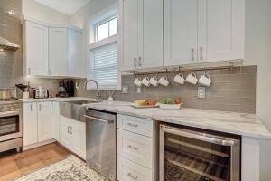 a kitchen with white cabinets and stainless steel appliances at Sunkissed Sands in St. Augustine