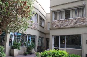 a building with windows and plants in front of it at Las Margaritas in Pila