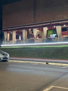 a car parked in front of a building at night at Apartamentos acogedores en el centro de Encarnación in Encarnación