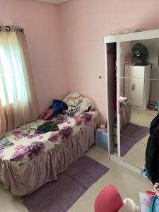 a small bedroom with a bed with a mirror at Casa para COP30 in Ananindeua +10 photos