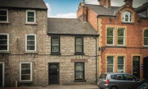 a car parked in front of a brick building at Mallview cottage in Armagh