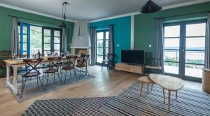 a living room with green walls and a table and chairs at Villa Amarina in Trogir