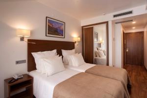 Postel nebo postele na pokoji v ubytování Hotel Miramar - São Pedro de Moel