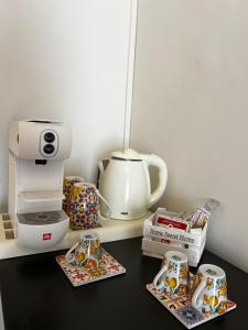 a counter with a coffee maker and some boxes of donuts at CASA DEL SOLE Accomodation in Tropea