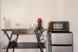 a table with a microwave and a coffee maker at Private Encinitas Casita & Patio in Encinitas