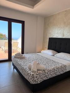 a bedroom with a large bed with a balcony at Villa Setharè in Salerno +54 photos
