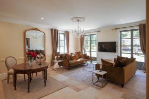 a living room with a couch and a table at Château de la Tour in Romanèche-Thorins