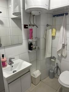 a white bathroom with a sink and a toilet at Aldo House in Prekal +28 photos
