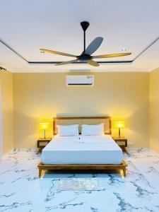 a bedroom with a bed with a ceiling fan at Chic & Modern Studio Oasis in Dar es Salaam
