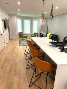 a large living room with a large counter and chairs at Modern Luxury 3BR 2BA 10 minutes to NYC in Weehawken