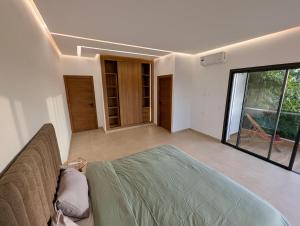 a living room with a couch and a large window at Villa 6chambres Aéroport de Fès Piscine Jacuzzi in Fès +29 photos