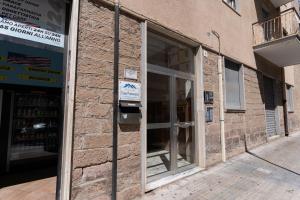 a brick building with an open door on a street at Casa Francesca in Sassari