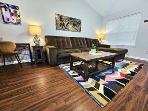 a living room with a couch and a coffee table at Pristine Elegance meets Chic Charm! in Tallahassee