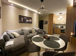 a living room with a couch and a table at Beli Bregovi Lux in Zlatibor