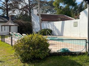 a swimming pool in a yard next to a house at Bungalows Solares de Colón in Colón