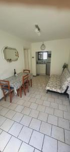 a living room with a table and chairs and a mirror at La Casetta in Marina di Massa +5 photos