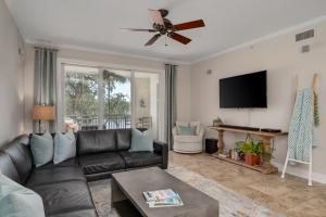 a living room with a black leather couch and a flat screen tv at 3br L Pool Family & Corporate Travel Sleeps 6 in Palm Coast